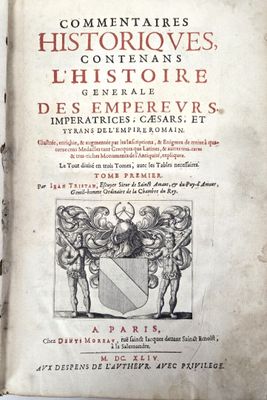 an old book with a picture of a coat of arms on it