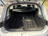 a car with its trunk open on the side of the road