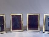 three silver picture frames are lined up against a white background