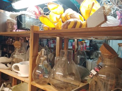 a shelf full of glass bottles and a bunch of bananas
