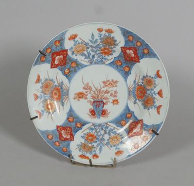 a blue and white plate with orange flowers on it