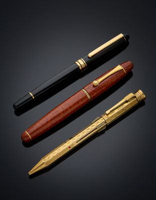 three different types of pens on a black background
