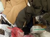 a pile of clothes and other items in a plastic bag