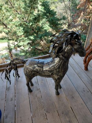 a statue of a horse on the porch of a house