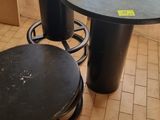 two stools and a table in the corner of a room