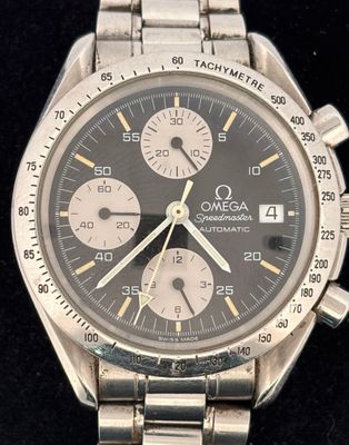 an image of a close up of a wrist watch on a black surface