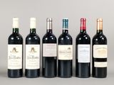 six bottles of wine are lined up in a row on a table