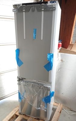 a refrigerator that is sitting on a pallet in a garage
