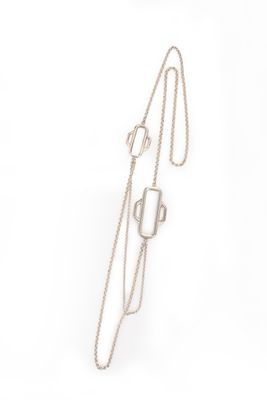 silver necklace with geometric shapes on a chain on a white background