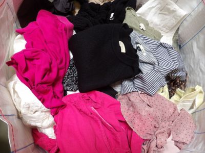a pile of clothes in a bag on the floor