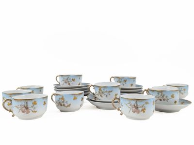 a group of cups and saucers sitting on a table