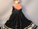 a doll in a black dress with a pink top and black skirt