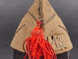 an image of a military hat with a red tassel on it
