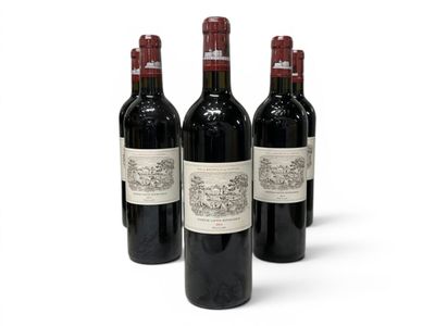 three bottles of red wine are lined up on a white surface