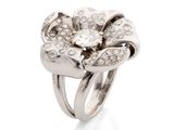 a close up of a diamond flower ring on a white background