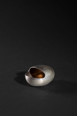 a close up of a metal object on a black surface
