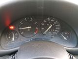 a close up of a car dashboard with a speedometer and gauges