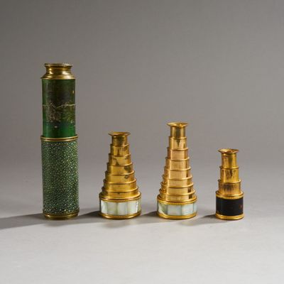 several different types of brass and green vases on a white surface