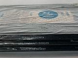 a stack of dvds wrapped in plastic on a table