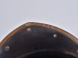 a close up view of a metal object with holes in it