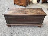 an old wooden chest on the floor in the room