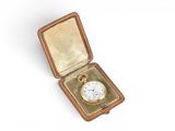 an old gold pocket watch in a case on a white surface