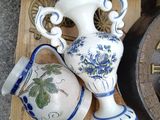 many vases and a clock sitting on a table