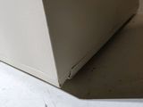 a white refrigerator sitting on the floor in a room