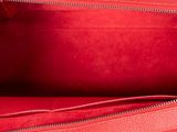 the inside of a red purse with two zippers open