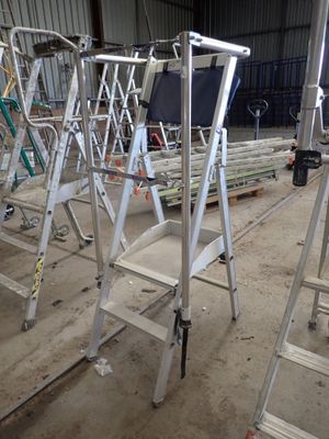 many ladders that are sitting in a building