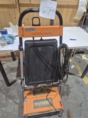 an orange and black machine that is sitting on the floor