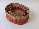 three woven baskets stacked on top of each other on a white surface