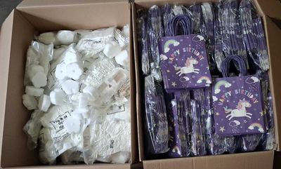 a cardboard box filled with lots of purple and white items