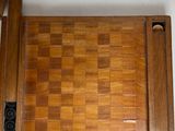a wooden table with a chess board on top of it