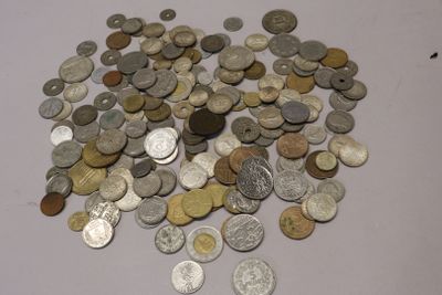 a pile of coins on a table with a white background