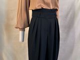 une photo d'un mannequin portant une chemise marron et un pantalon noir
