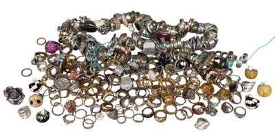 a pile of rings and other jewelry on a white surface