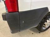 a close up of a truck with a tire on the side of it