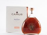 a picture of a bottle of brandy in front of a box