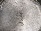 a close up of a metal bowl with a metal lid