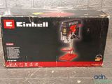the box of a drill is sitting on the floor next to the box