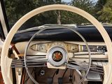 a steering wheel and dashboard of a car with wood trims