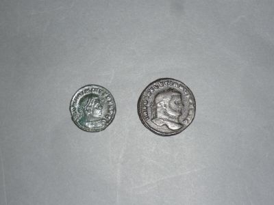two silver coins sitting next to each other on top of a table