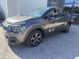 a grey citrole parked in front of a building