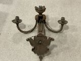 a wall mounted candle holder that has a clock on it
