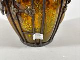 a close up of a vase on a table with a white background