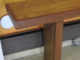 an image of a wooden bench in a public restroom