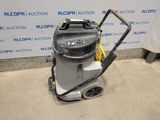 a vacuum cleaner is sitting on the floor in front of a wall