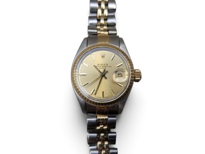 a close up of a watch on a white surface with a white background