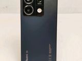 a close up of the back of a black phone with a camera on it